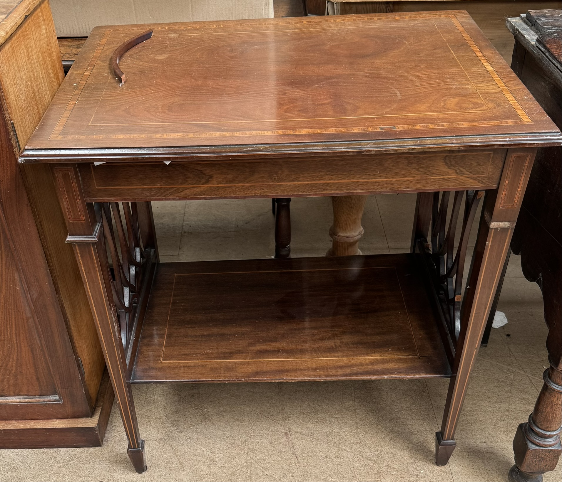 An Edwardian mahogany occasional table with a rectangular moulded top above four square tapering