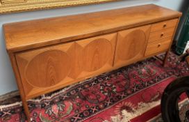 A mid 20th century teak sideboard with a rectangular top above three cupboards and three drawers on