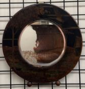 A circular wall mirror of Art Deco style decorated a lake scene,