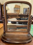 A Victorian mahogany toilet mirror with bobbin twist uprights on a D shaped base