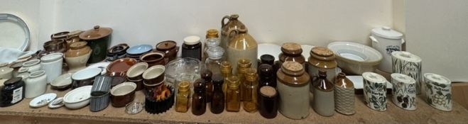 An extensive lot including pottery storage jars, pottery mixing bowls, stone ware bottles,