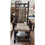 A child's American rocking chair with an upholstered seat and back
