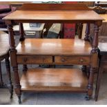 A Victorian mahogany dumb waiter with a rectangular moulded top above a central shelf with two