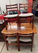 A mid 20th century teak extending dining table and six chairs