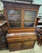 A mahogany bureau bookcase with a moulded cornice above a pair of glazed doors with leaded glass