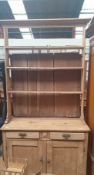 A Victorian pine dresser, the moulded cornice above three shelves,