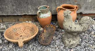 Three terracotta pots together with a small cast iron drinking trough,