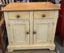 A painted pine side cabinet with a pair of drawers and a pair of cupboards on bracket feet
