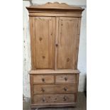 A Victorian pine linen press, the moulded cornice above two cupboard doors,