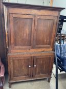 A 19th century linen press with a moulded cornice above a pair of cupboard doors,
