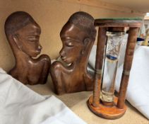 A pair of carved bookends attributed to Hagenaur and an egg timer