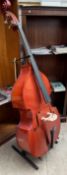 A three quarter double bass, together with a bow,