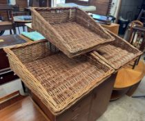 A set of three wicker sloping display baskets