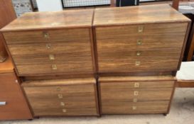 A set of four mid 20th century rosewood chests of drawers with recessed brass handles