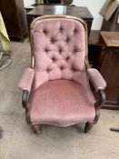 A Victorian rosewood library chair, with a button upholstered back,