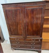 A 19th century mahogany linen press with a moulded cornice above a pair of cupboard doors and linen