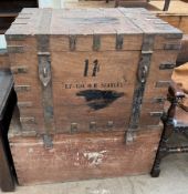 A metal bound trunk with hasp locks together with another trunk