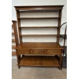 A 20th century oak dresser, the open rack with a moulded cornice above three shelves,