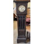 A 20th century oak longcase clock with a moulded cornice and glazed door with bevelled glass panels
