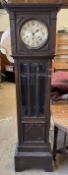 A 20th century oak longcase clock with a moulded cornice and glazed door with bevelled glass panels