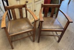 A pair of elbow chairs with pad seats on square legs