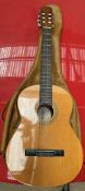 A Spanish acoustic guitar bears a label for BM Sevilla