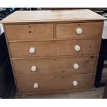 A Victorian pine chest with two short and three long drawers on a plinth