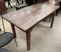A provincial refectory table possibly ash, with a planked top on square tapering legs,