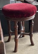 A Victorian mahogany framed piano stool with a circular pad seat on splayed legs