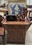 A Chinese hardwood alter table together with carved figures,
