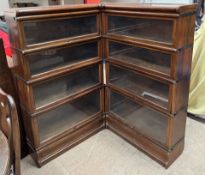 A mahogany Globe-Wernicke corner bookcase with eight sections on a plinth base