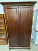 A modern Willis & Gambier mahogany wardrobe with a moulded cornice and a pair of cupboard doors on