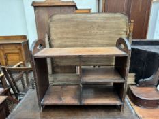 An Arts and crafts style shelf unit with carved and painted ends,