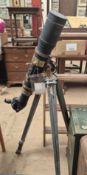 A brass and black painted telescope, possibly military,