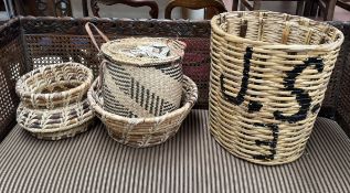 A pair of bamboo baskets together with caned baskets