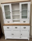 A modern white painted dresser with a glazed top and shelves, the base with drawers and cupboards,