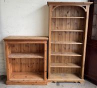 A pine bookcase with a moulded cornice and shelves on bracket feet together with a small pine