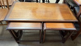 A G-Plan teak coffee table together with a pair of occasional tables