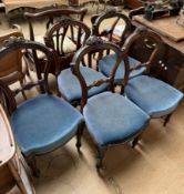 A set of five Victorian dining chairs with carved backs and a pad seat on tapering legs