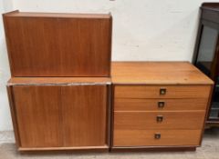 A G-Plan teak chest of four drawers together with a teak bureau and a teak cabinet with sliding