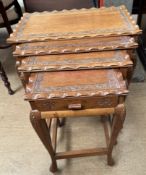 A carved Chinese quartetto nest of tables on cabriole legs and pad feet