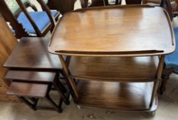 A mid 20th century tea trolley together with an oak nest of three tables