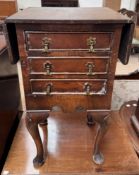 A Victorian style mahogany work table with drop flaps and three drawers on shell capped cabriole