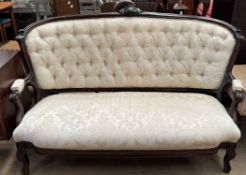 A Victorian button back upholstered three seater settee on shaped legs