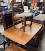 A mid 20th century Portwood Furniture Ltd teak extending dining table and four chairs