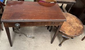 A 19th century mahogany tea table with a foldover top on square tapering legs together with an