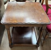 A 20th century oak occasional table with a square top on ring turned tapering legs united by an