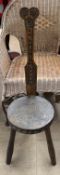 A Ben Setter of Totnes stool with a carved bar back and circular seat with three legs