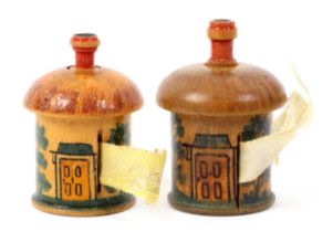 Two whitewood paint decorated Tunbridge ware cottage form cylinder tape measures, both with