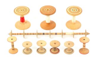 A group of whitewood ring painted Tunbridge ware reels, comprising three large format reels, circa